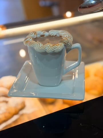 Coffee served in a pale blue cup at the Floré counter