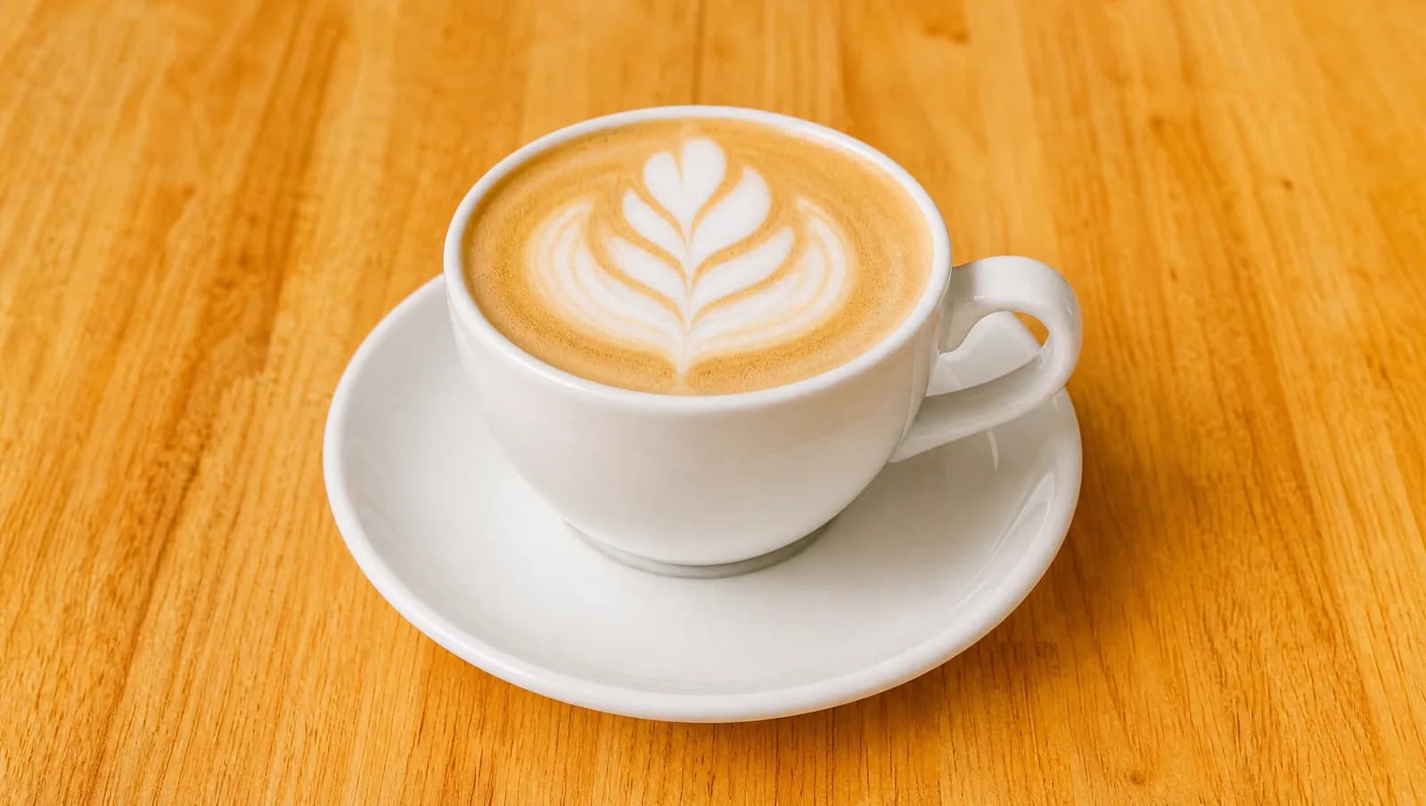 Latte with latte art in a white cup at Floré Café & Kitchen